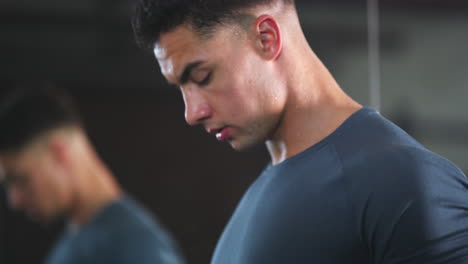 a fit young man working out with dumbbells