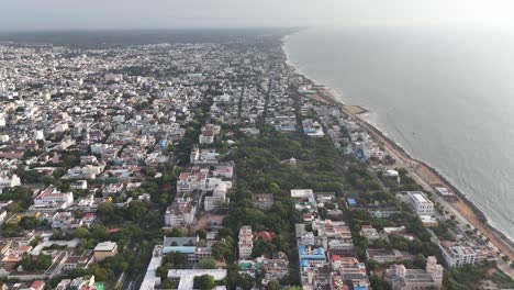 view of the layered coastal settlement and tropical greenery from above