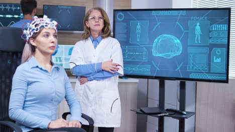 focused female neuroscientist making hand gestures