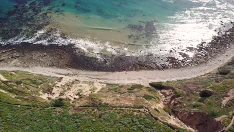 4K-Aerial-View-of-a-Oceanfront-Golf-Course-in-Los-Angeles,-California-with-Players-Playing-Golf-with-Crystal-Clear-Water-on-a-Warm,-Sunny-Day