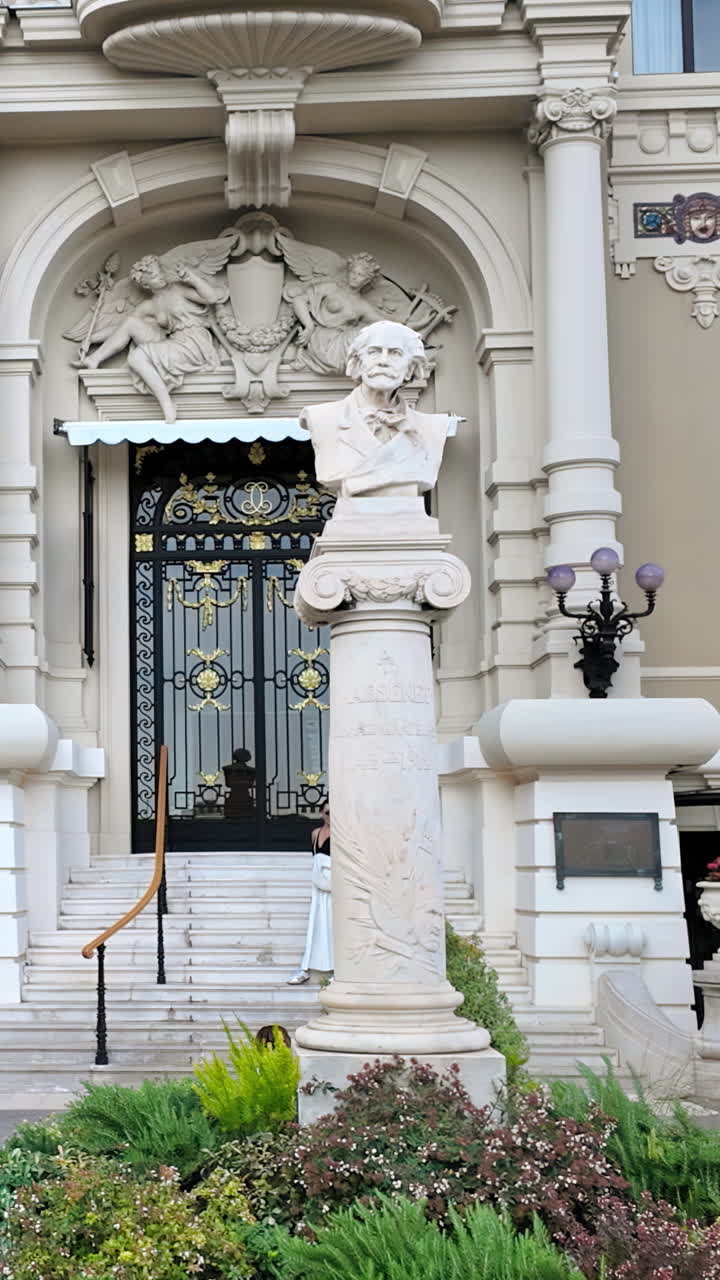Close up of a statue in front of the Opera de Monte-Carlo in daylight. Vertical