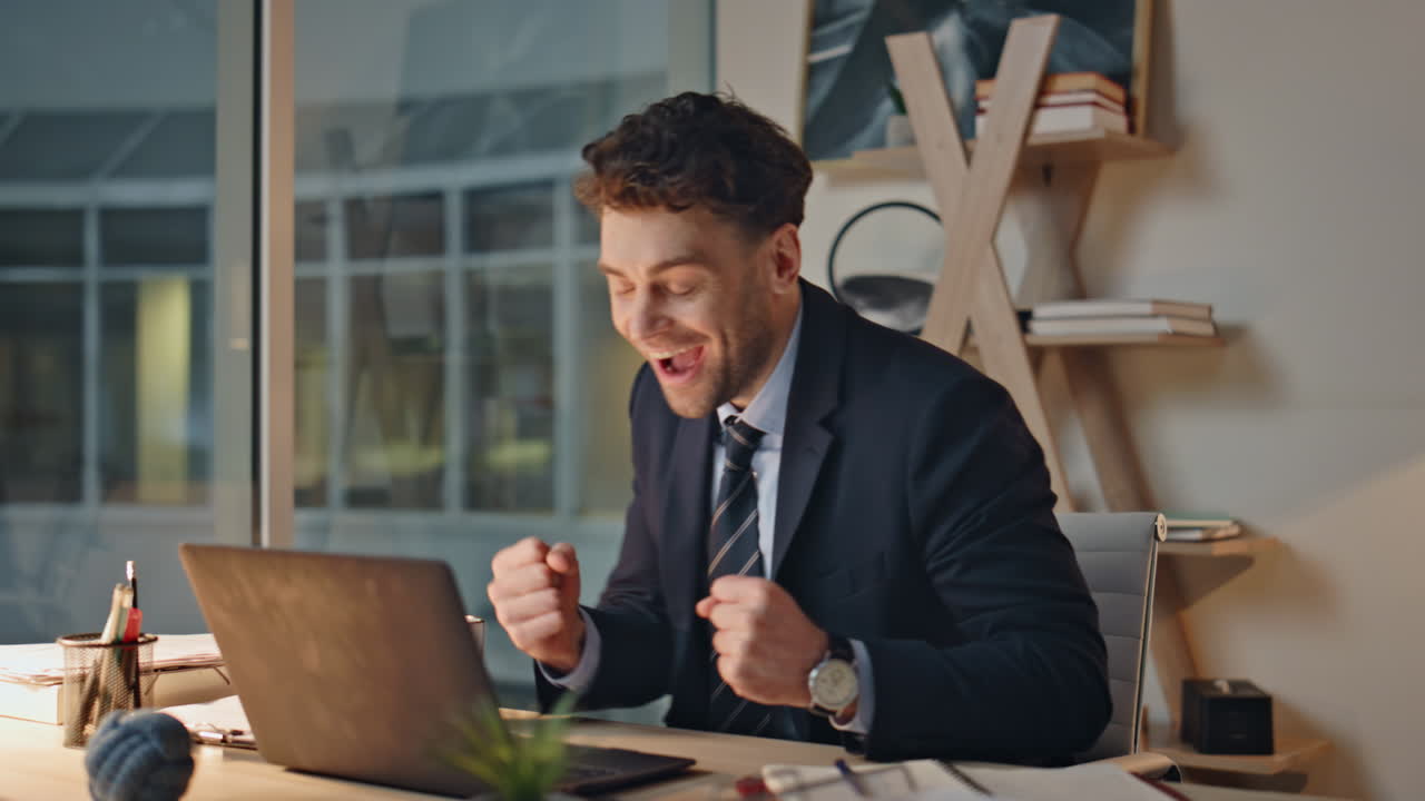 Overjoyed manager working laptop receiving great news in email at office closeup