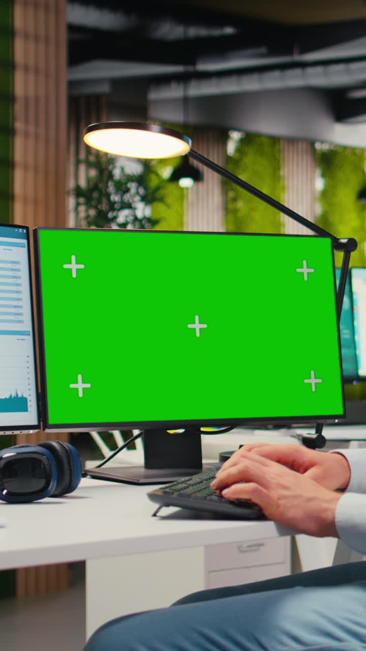Vertical Video Business manager working on report writing next to chroma key screen