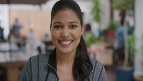 close up portrait of beautiful mixed race woman smiling happy looking at camera enjoying successful urban city lifestyle outdoors restuarant background