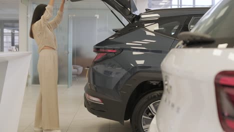 woman choosing a car in a car showroom