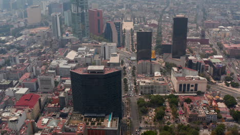 Aerial-drone-tilting-down-view-of-downtown-cityscape.-High-variety-of-buildings.-Mexico-city,-Mexico.