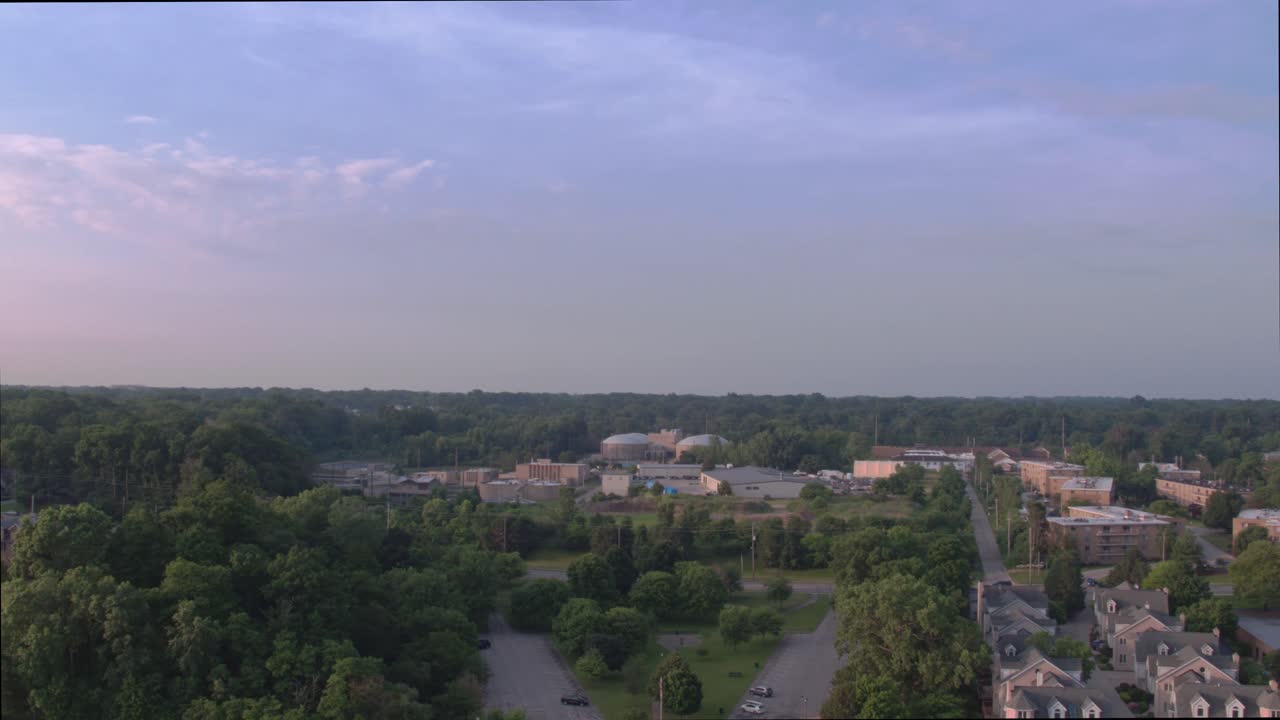 Lake Erie beach front park, facing south, showing green trees, residential neighborhoods and office buildings