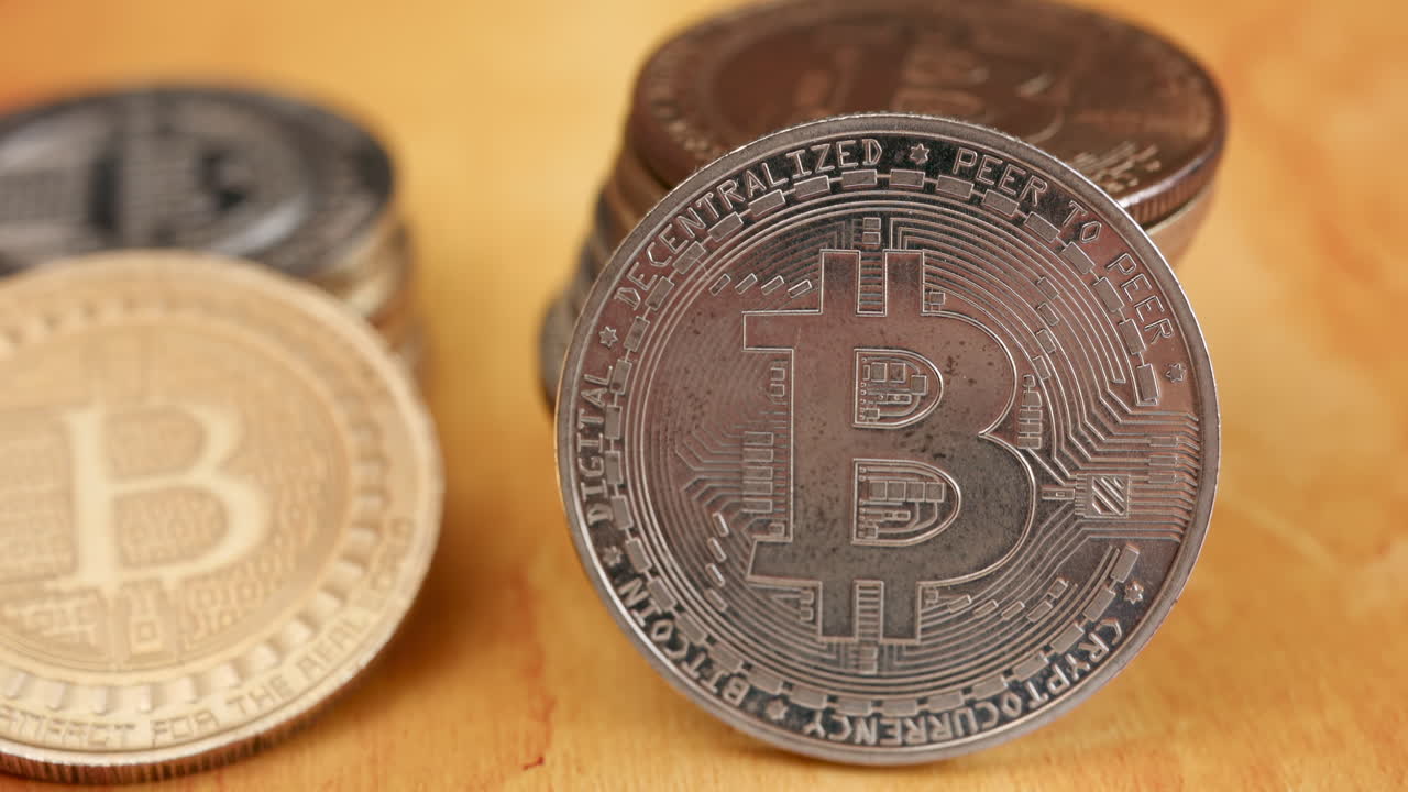 Close up of shiny physical Bitcoin coins stacked on a table