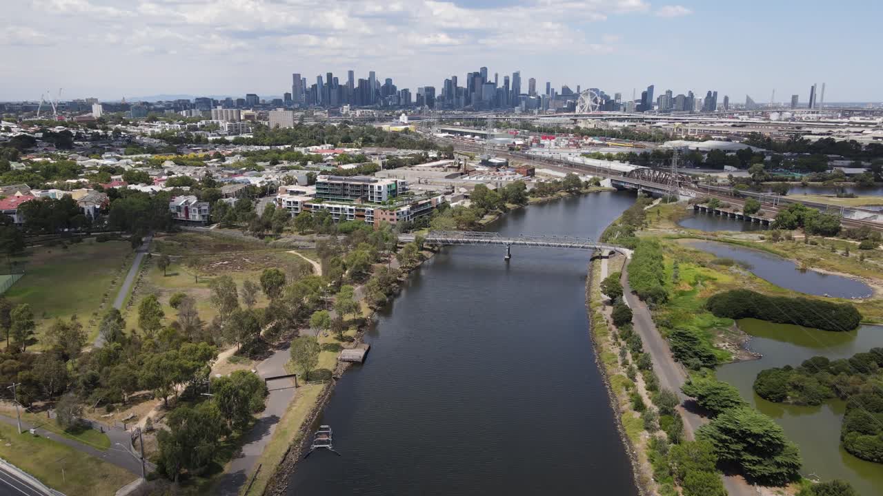 Aerial drone over Maribyrnong River, moving towards Melbourne city skyline