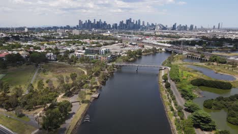 aerial drone over maribyrnong river, moving towards melbourne city skyline
