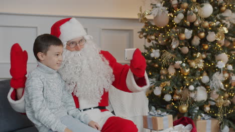 santa claus taking a selfie with a child