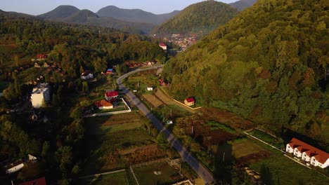 aerial view overlooking the shayan town, during golden hour, in the carpathian mountains, ukraine - rising, drone shot