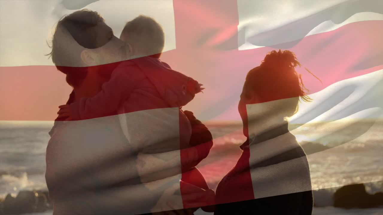 Family with flag overlay walking on beach during sunset, enjoying animation