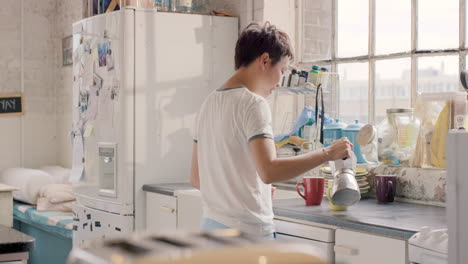 Happy-mixed-race-couple-at-home-wearing-pyjamas-intimate-hugging-making-coffee-together