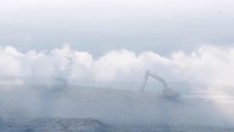 animation of clouds over digger in waste disposal site