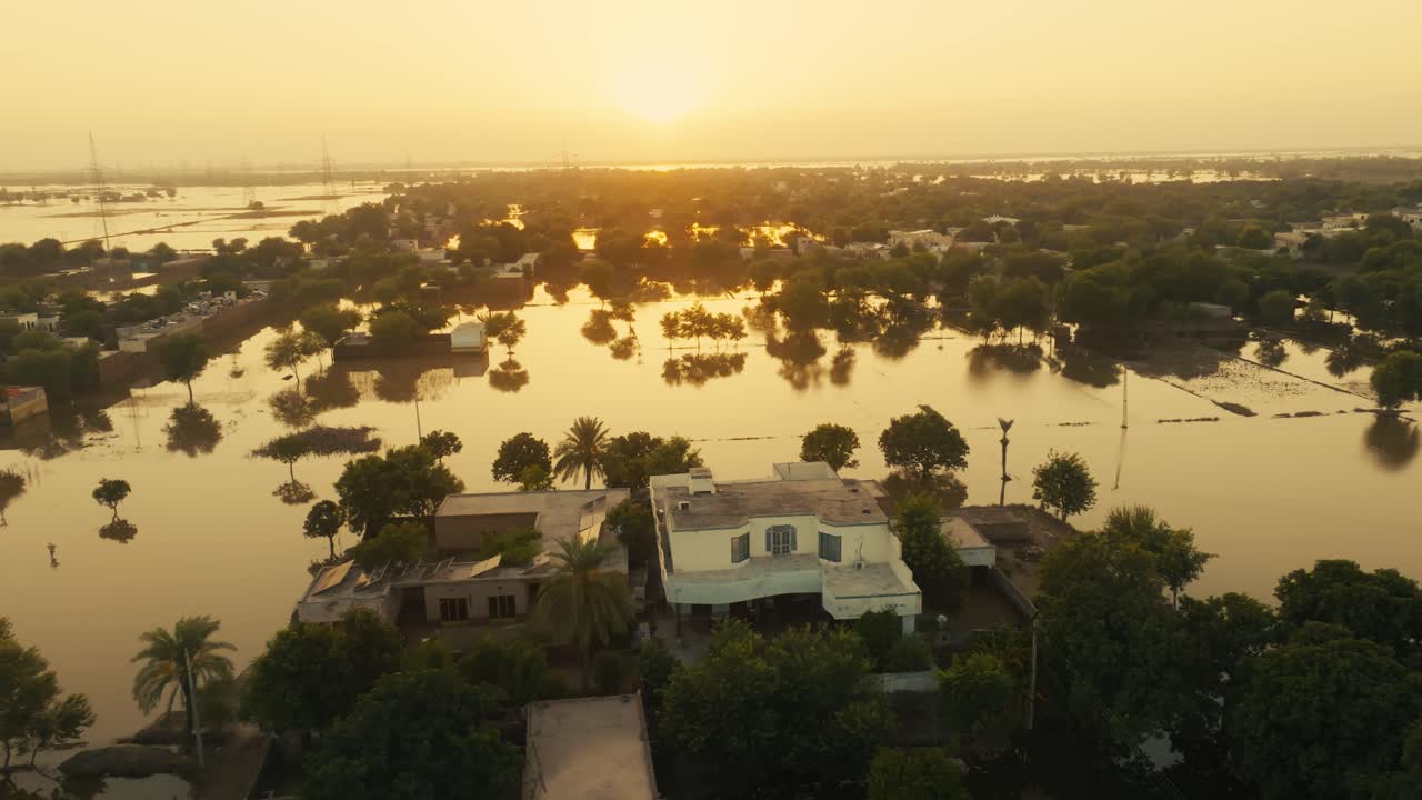 Homes and properties submerged by massive floodwaters at dusk in Pakistan