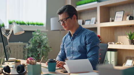 handsome freelancer typing computer working office closeup. man browsing online