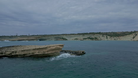 passing-over-a-rock-in-Hofriet-Window,-aerial