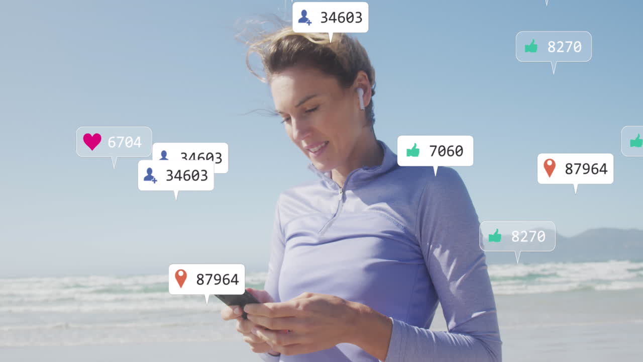Animation of social media data processing over caucasian woman with smartphone on beach