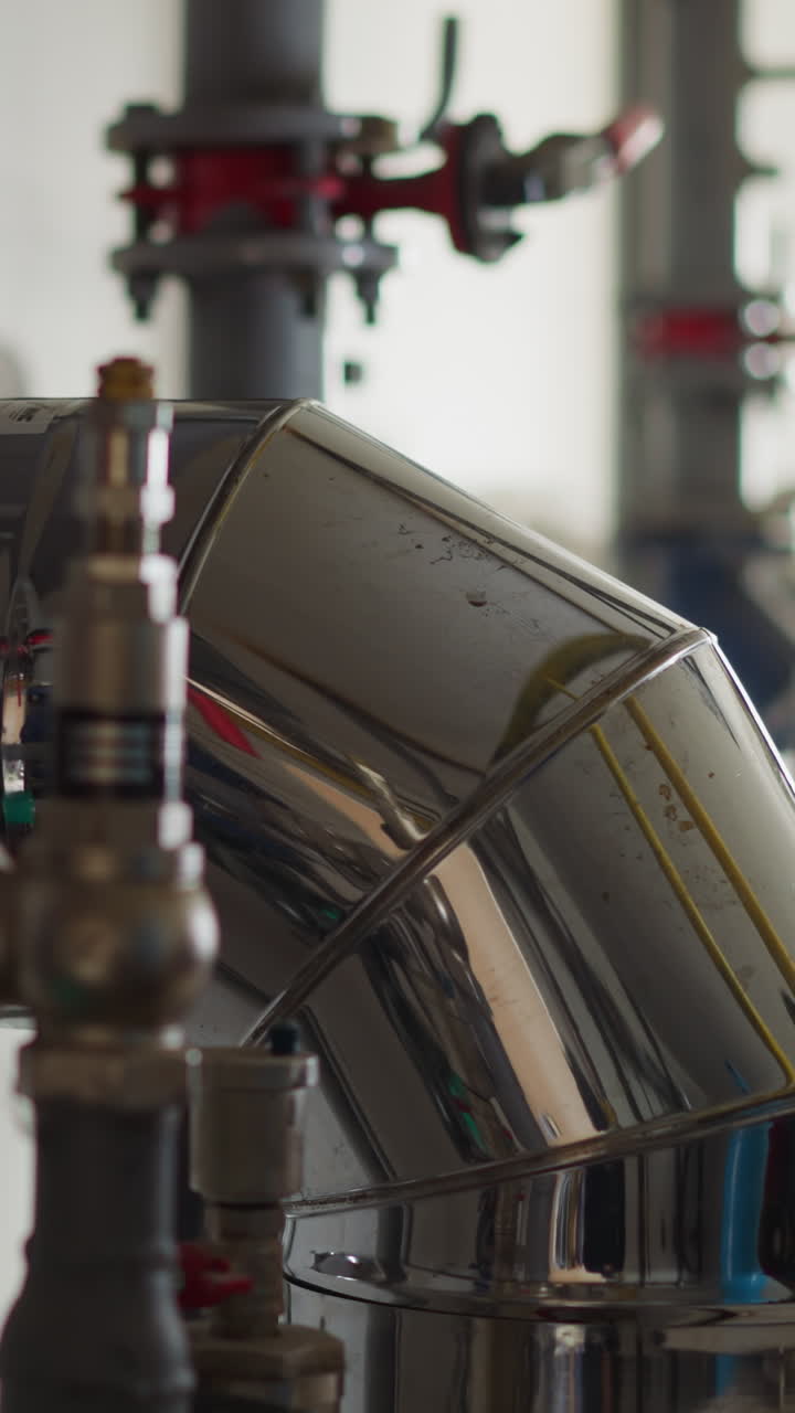 Shiny metal ventilation pipe for air regulation in plumbing system closeup. Conditioning system part in building mechanical room. Cooling equipment
