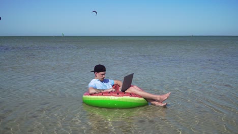 a young business person is enthusiastically working behind a laptop swaying on the waves of sea