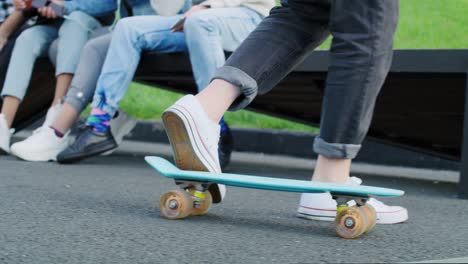 handheld view of hipster woman riding on skateboard