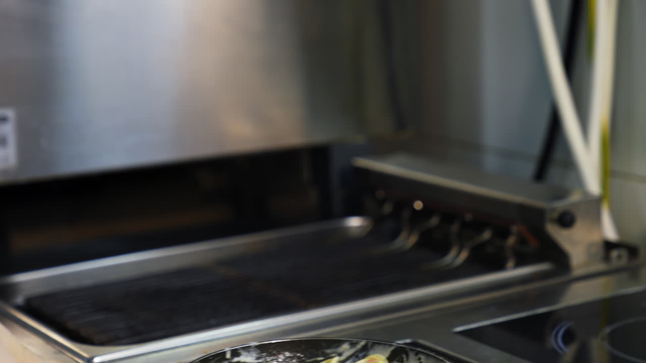 Chef cooking food with pan. Chef preparing food in the restaurant kitchen