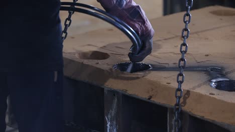 safety first concept, casting, melting, molding and foundry, water molten metal being poured from the crucible into the sand mold