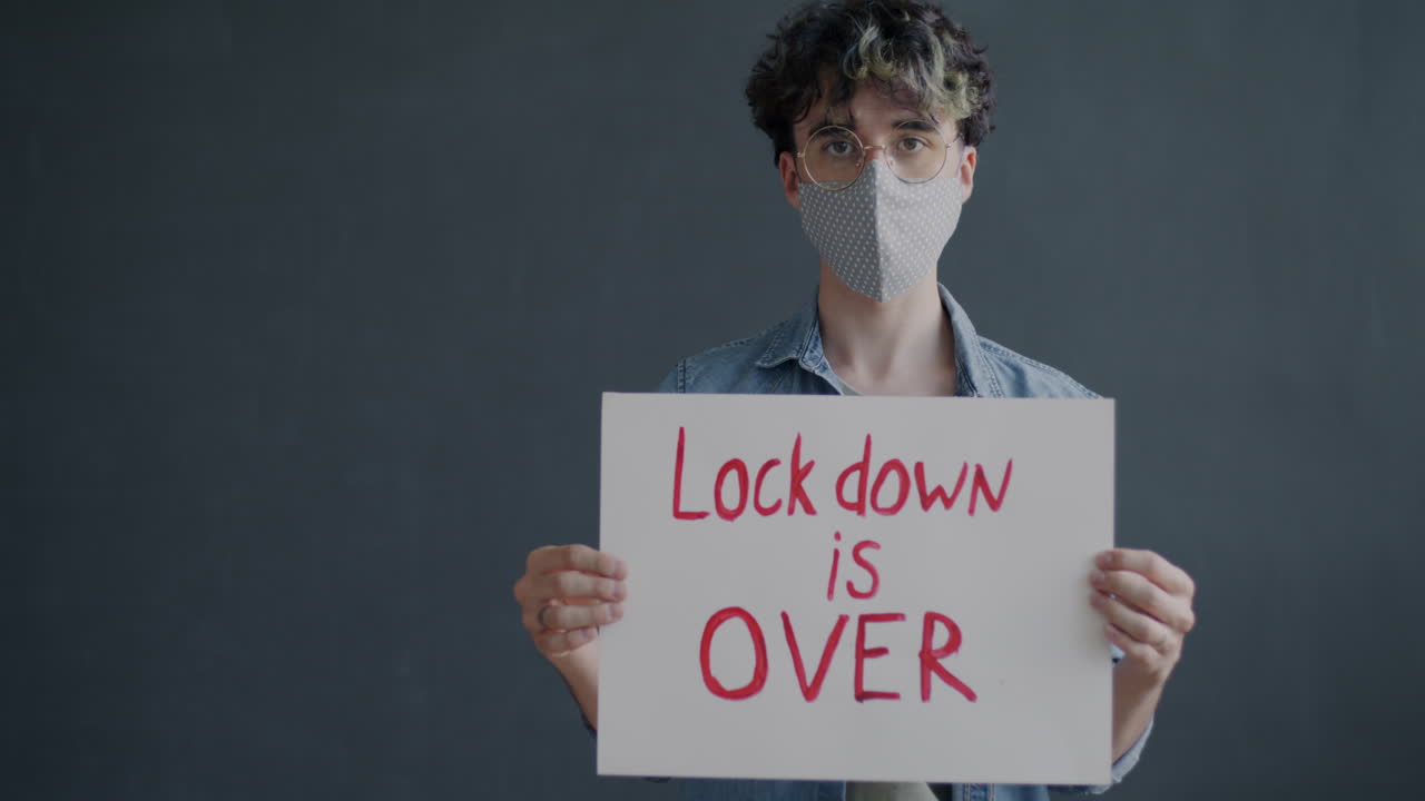 Person Holding Sign Saying Lockdown is Over