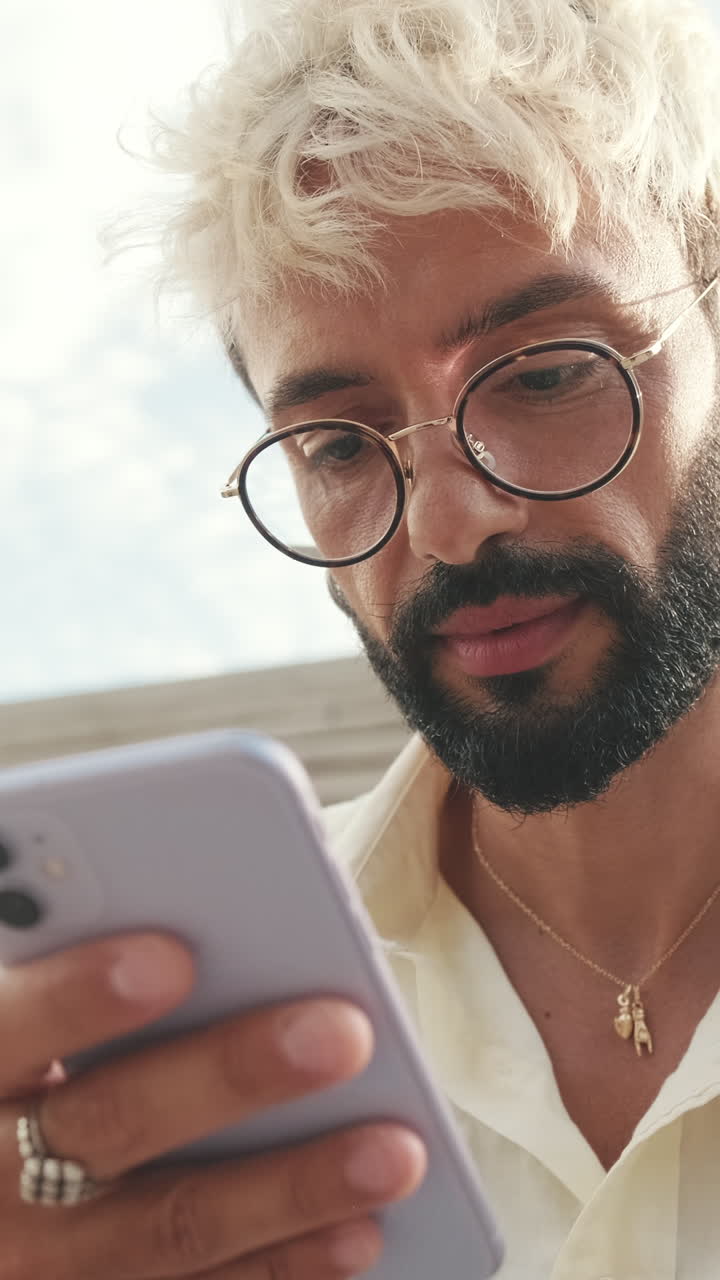 Man with glasses using a phone