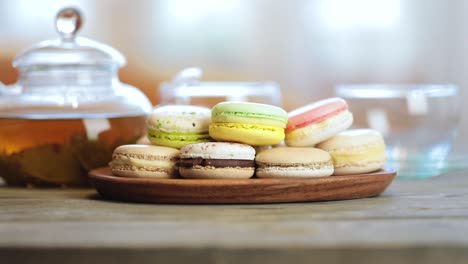 close-up of colorful macaron (macaroon) on the table with hot tea