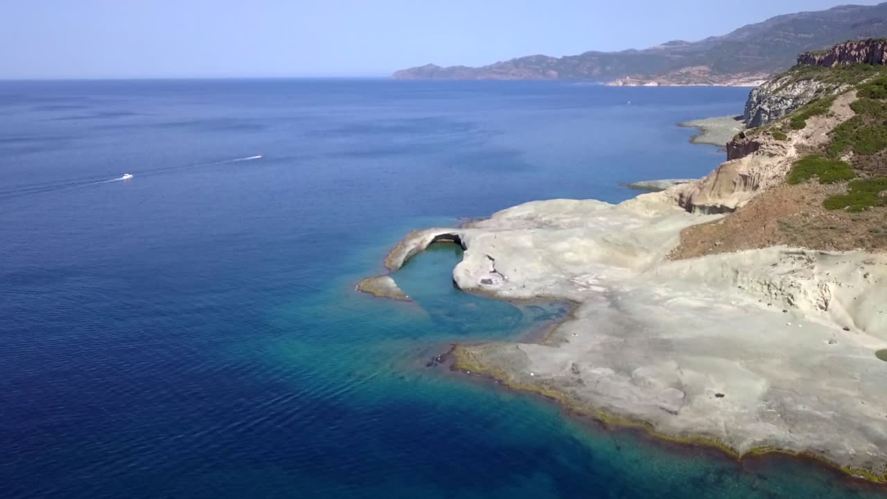 Drone Aerial shot over the natural swimming pool of Cane Malu in Sardinia, Italy. A wonderful typical mediterranean coastal  landscape