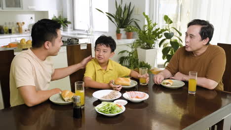 asian men and boy sitting at the table