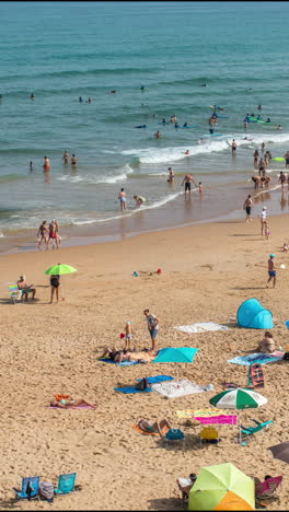 crowded beach, in galicia, spain in the summer in vertical