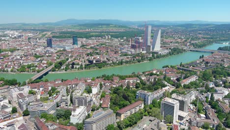 basel: aerial view of city in switzerland at border with france and germany, knee of river rhine in center of city, clear blue sky - landscape panorama of europe from above