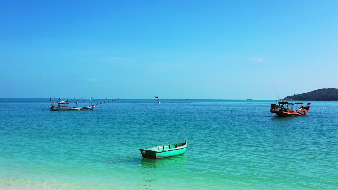 모래사장 근처에 보트가 떠 있는 푸른 바다