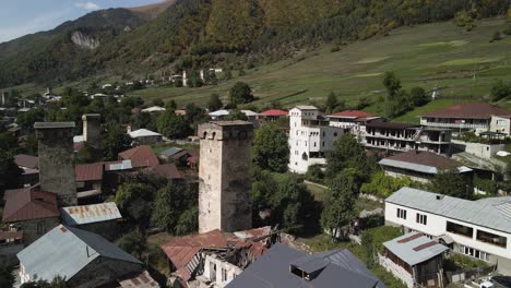 Drone-view-of-residential-and-Caucasus-mountain-in-background,-Svaneti,-Georgia