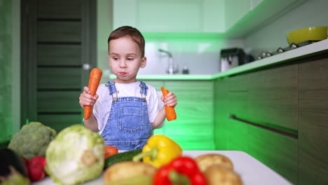 cute kid eating a carrot looks at the diversity of vegetables. lively baby picks another carrot. healthy lifestyle.