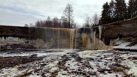 Estonia,-scenic-aerial-view-of-Jägala-Waterfall-Jägala-River,-natural-forest-park-near-the-Gulf-of-Finland,-drone-nature-footage