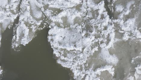 icy waters near southampton with floating ice sheets in winter, aerial view