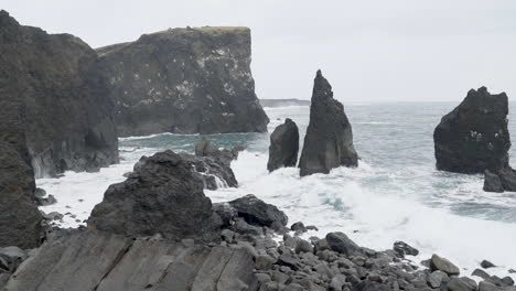 waves breaking on cliffs at rocky coastline of iceland