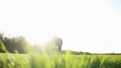 bright, sunny day. father enjoys his time with little daughter. girl rushes to the dad and hug him. young man ups the daughter to his arms. green grass