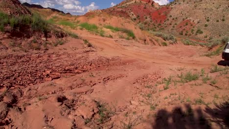 a car travels trough a desert region and becomes stuck in sand