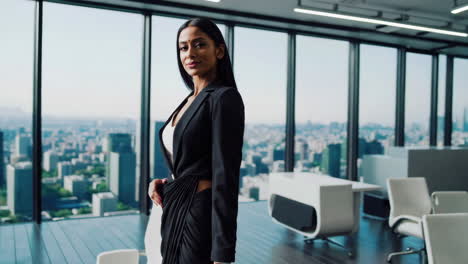 confident businesswoman in a modern office with city view