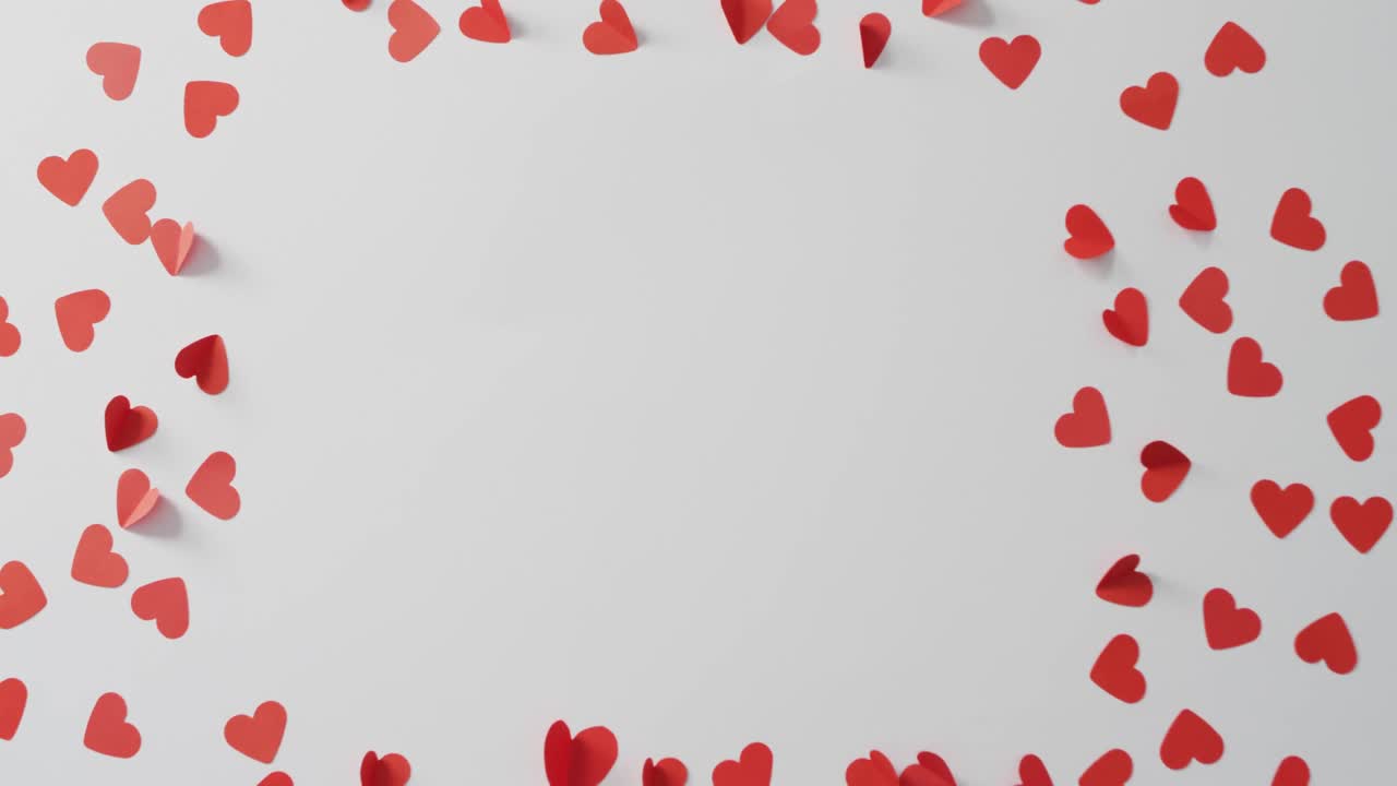 Red paper hearts on pink background at valentine's day