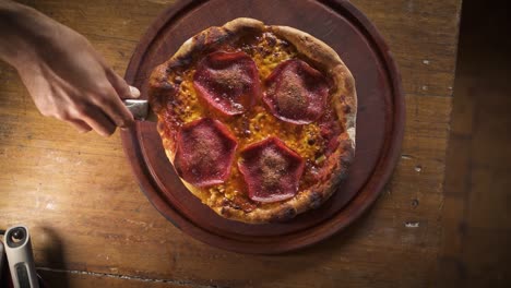 Seasoning-with-olive-oil-hot-smokey-delicious-homemade-pepperoni-pizza-in-wooden-table-top-view-Slow-Motion-60FPS