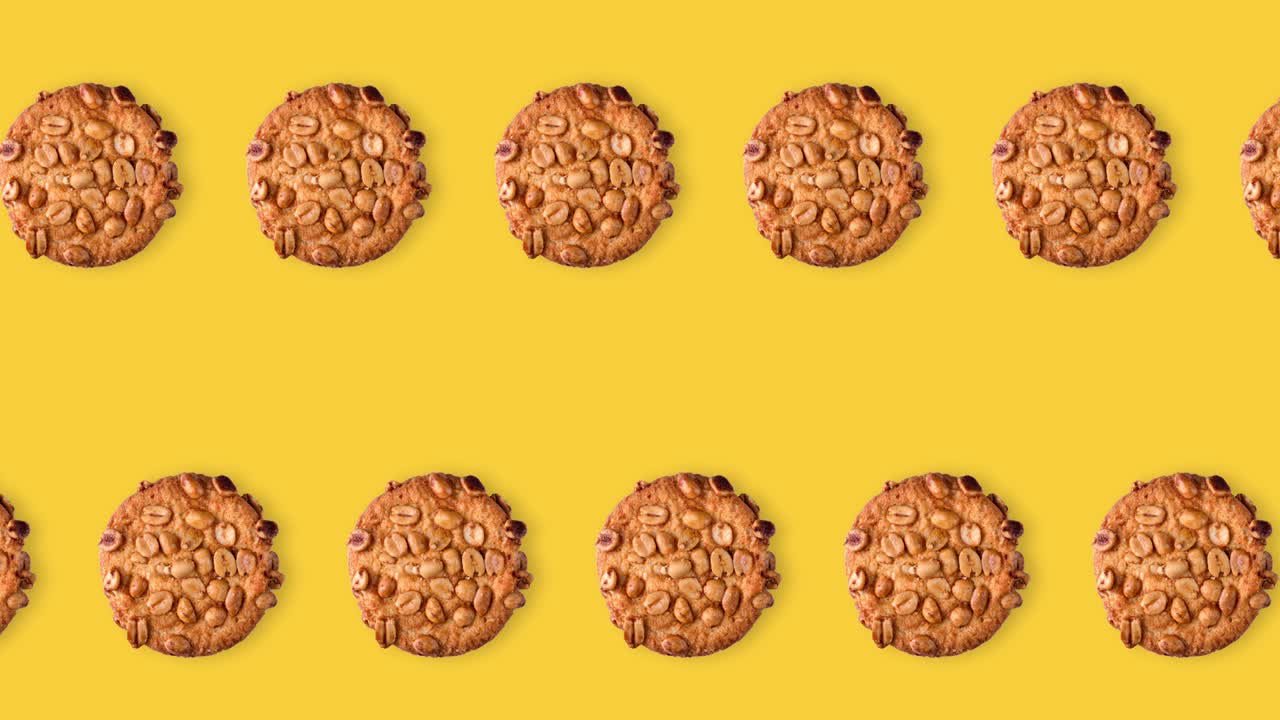 seamless looping animation of peanut cookies. two rows of homemade pastries animated on a yellow background