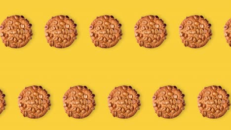 seamless looping animation of peanut cookies. two rows of homemade pastries animated on a yellow background