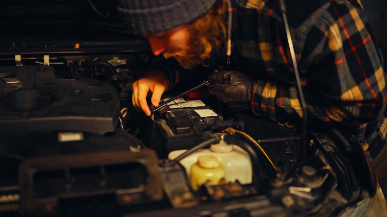 Person Working On The Engine Of A Car - Close Up
