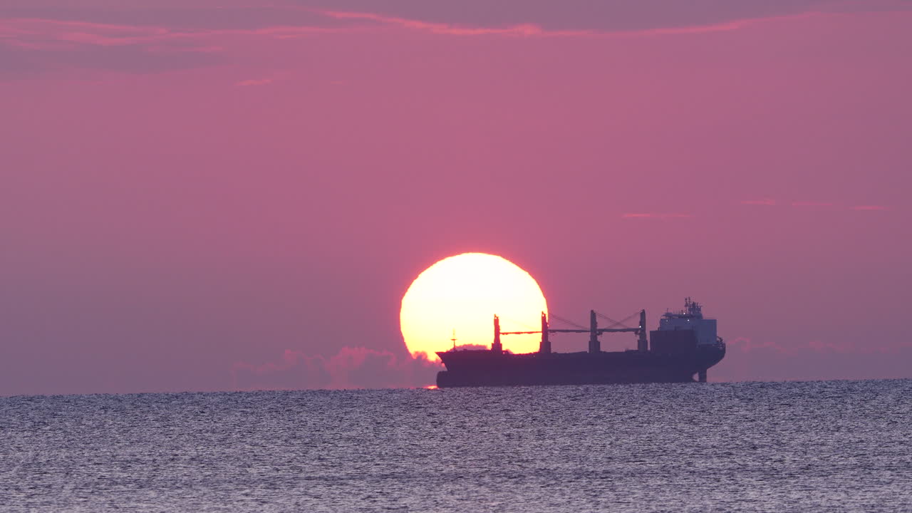 Gdynia Orłowo pier during sunrise, bathed in golden light over tranquil waters